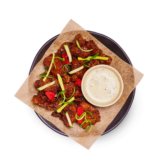coated in hot honey and your choice of sauce. topped with
mixed pickles and served with a zesty vegan mayo on the side