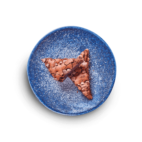 a delicious + decadent chocolate brownie filled with mini chocolate chips. dusted with icing sugar